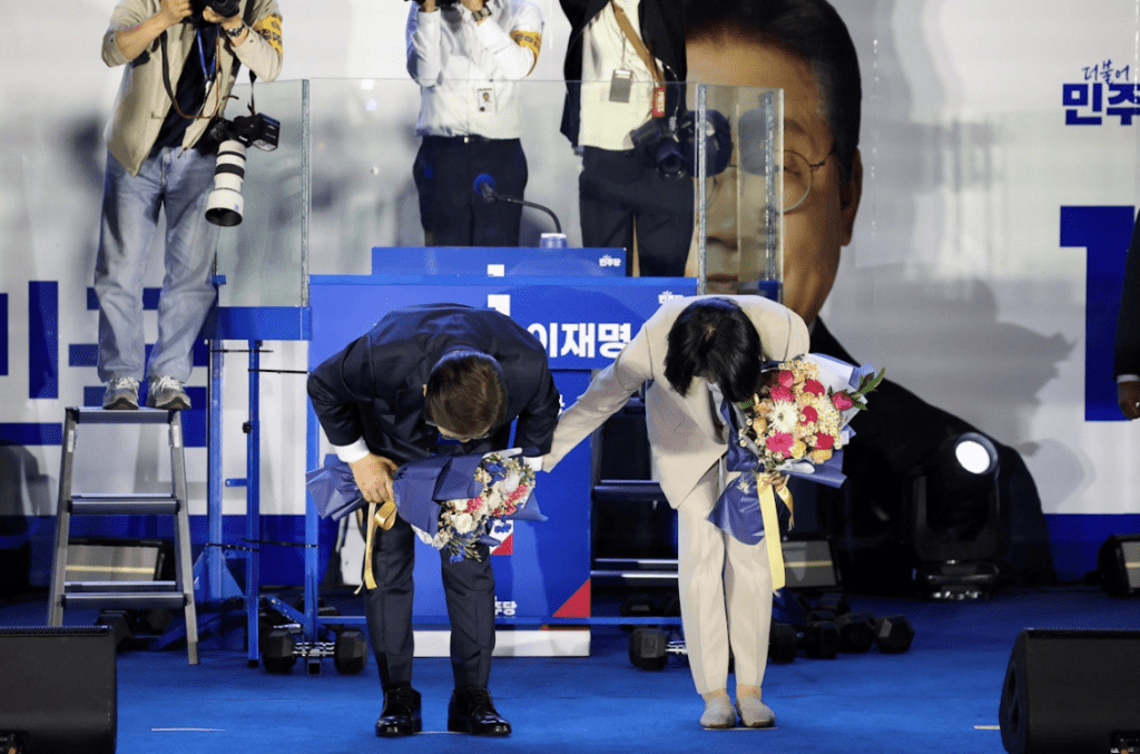 當選後，李在明與太太向支持者鞠躬致謝。路透社
