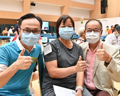 聶德權(左)、西貢區滅罪委員會主席吳仕福(右)與市民(中)一同支持疫苗接種計劃。政府新聞處