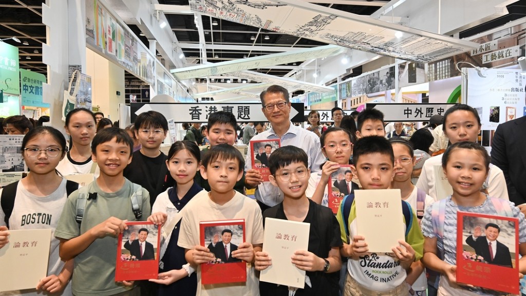 陳茂波為小學生介紹習近平主席三本著作新近的繁體版。陳茂波網誌圖片