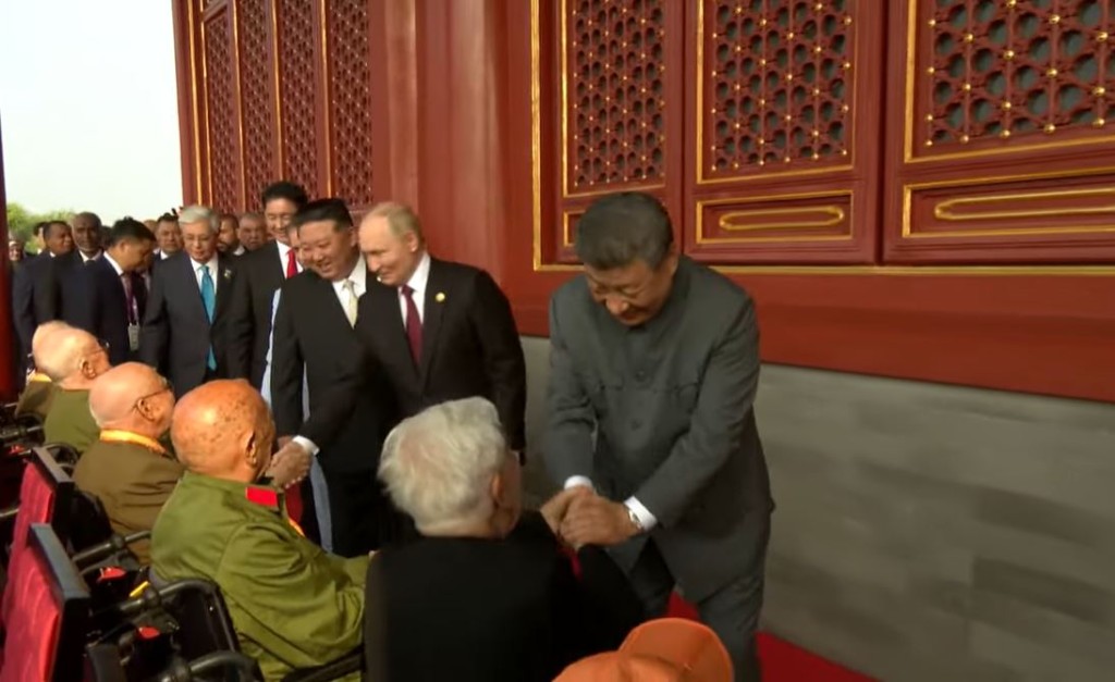 習近平與抗戰老戰士握手致意，包括香港老戰士羅競輝（右一）。