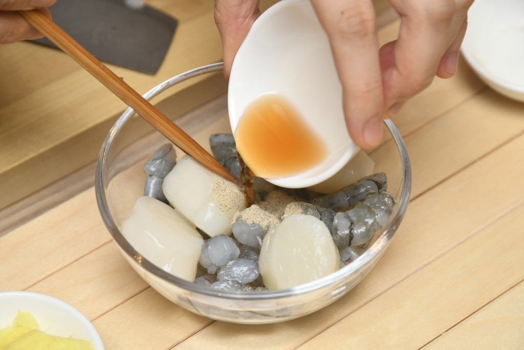 Step 2: 帶子及蝦仁用醃料醃十分鐘。Marinate the scallops and shrimps for 10 minutes.