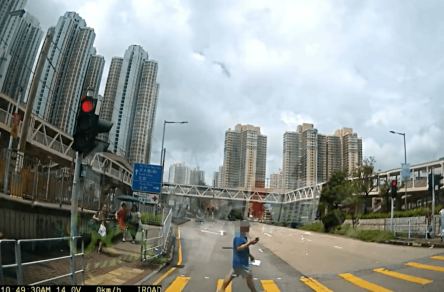 男子邊看手機邊過馬路。fb： 交通意外求片區