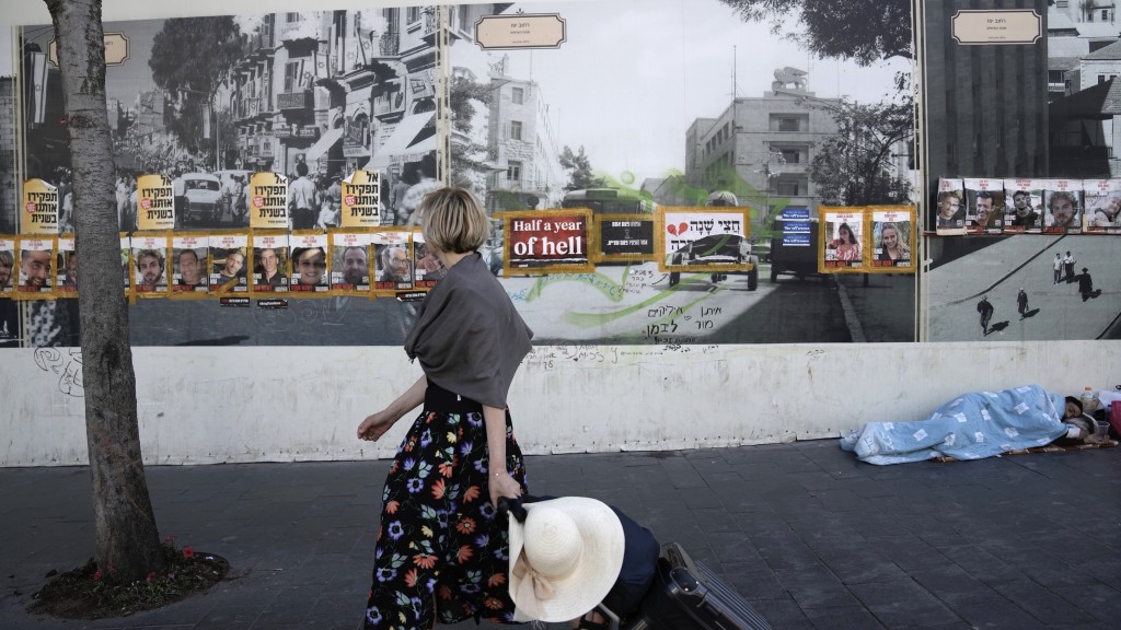 耶路撒冷路边墙壁贴满被哈马斯掳走的人质的照片。 美联社