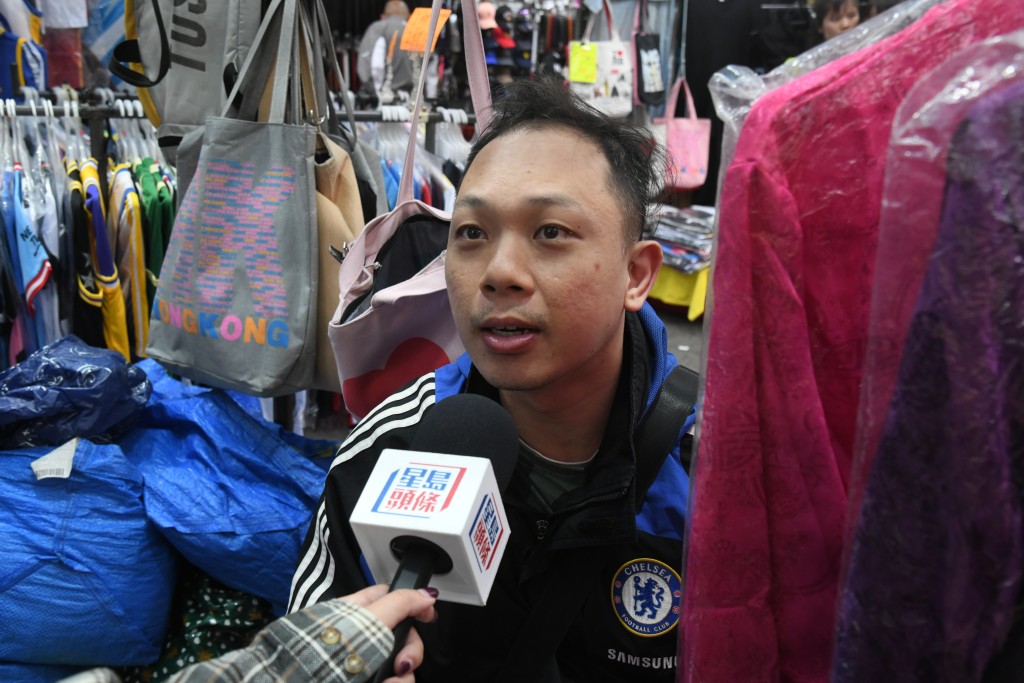 摊贩邓先生在旺角售卖球衣，指一半盈利来自游客。何健勇摄