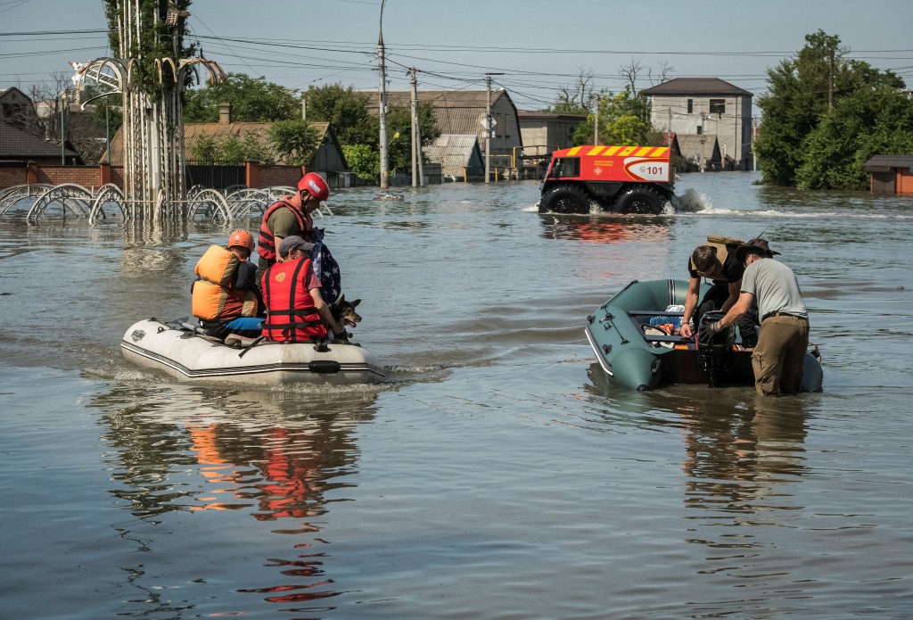 救援人員利用橡皮艇從洪水泛濫的地區疏散當地居民。路透社