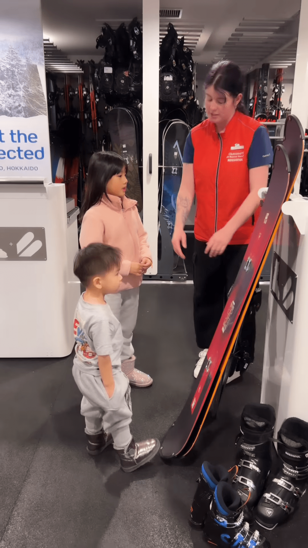 其间2岁细仔Tristan认真地听职员讲解滑雪装备。