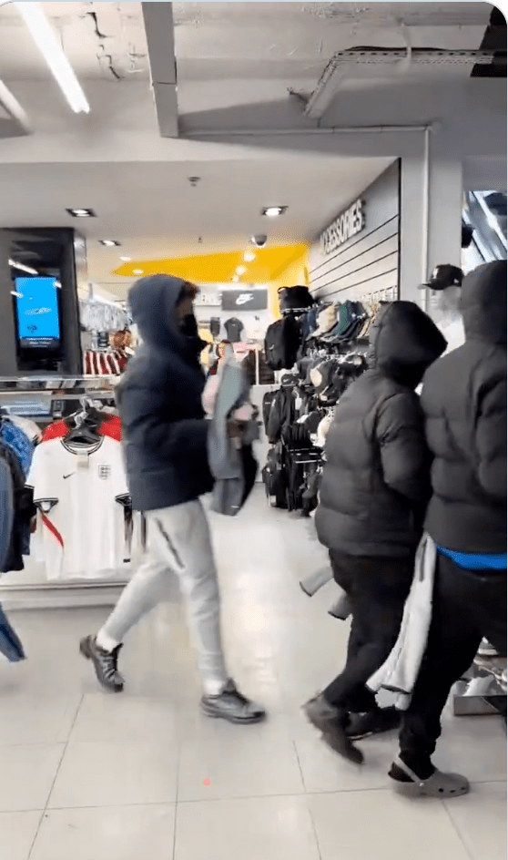 影片顯示，這群青年在店內大肆搜刮後，抱著大量名牌運動服飾奔向扶手電梯。
