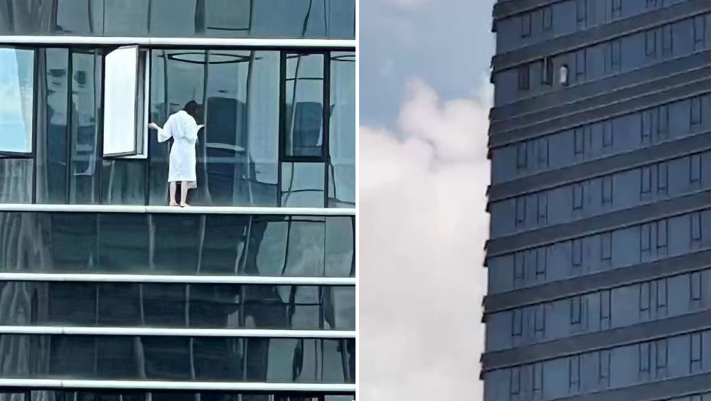 廣州穿浴袍女子危站高樓窗外。