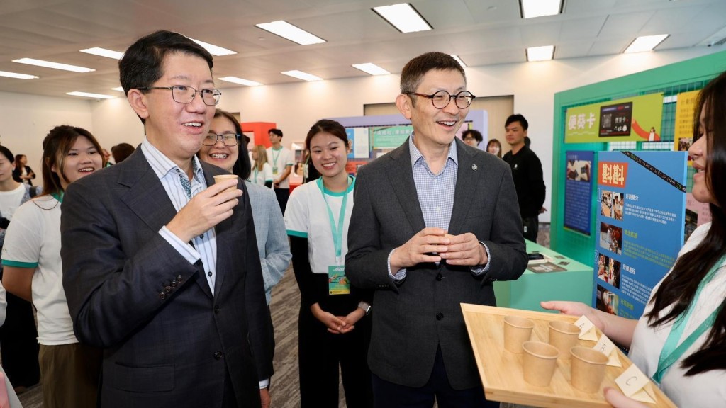 社會福利署署長杜永恒（左）及香港賽馬會董事羅碩瀚（右） 與參與 21C@JC 計劃嘉年華的年輕人交流。