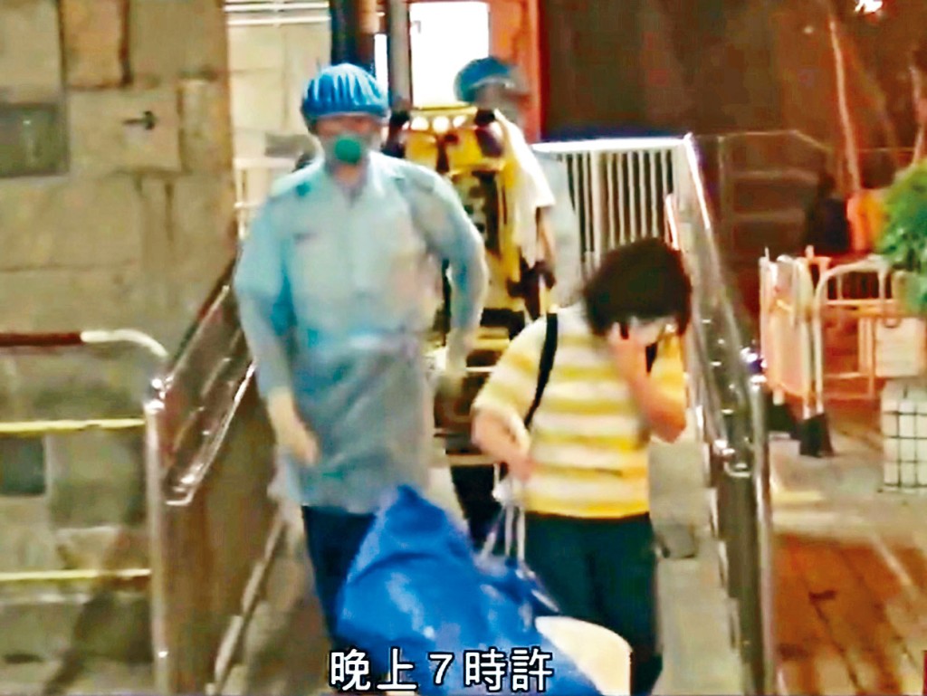 救護員將患者新抱送院。電視畫面