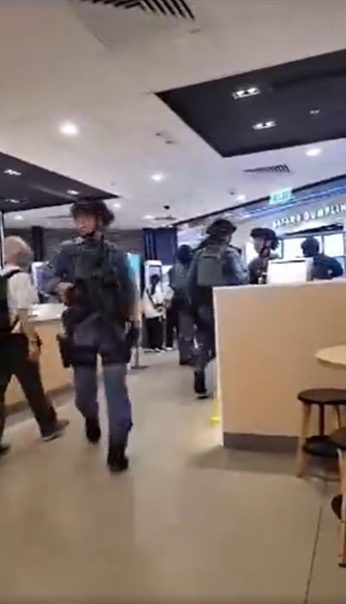 警員手持衝鋒槍及穿著防彈背心，在商場餐廳內搜查。網上圖片