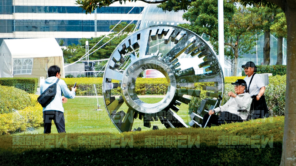 謝賢在外傭陪伴下在公園悠閒曬太陽。