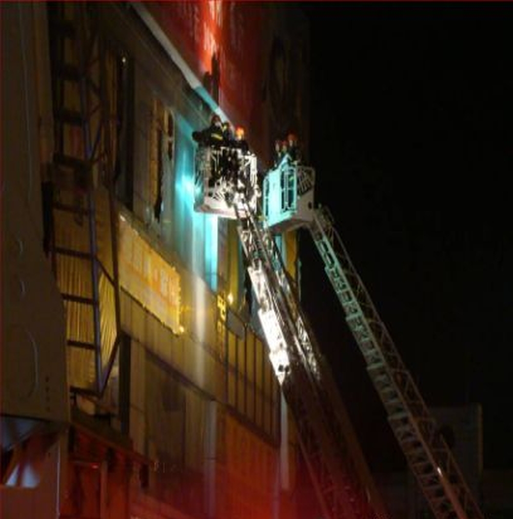 2008年深圳舞王俱樂部火災現場，消防員用雲梯升到三樓救人。