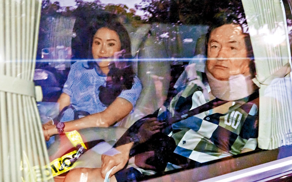 戴着医疗颈箍的他信昨由女儿、为泰党党魁贝东丹陪同乘车离开曼谷警察医院。 