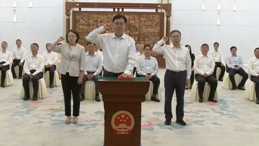 陳瑞峰(前)和雷建斌(右)分別宣誓就職國家民委主任及香港基本法副主任。央視截圖