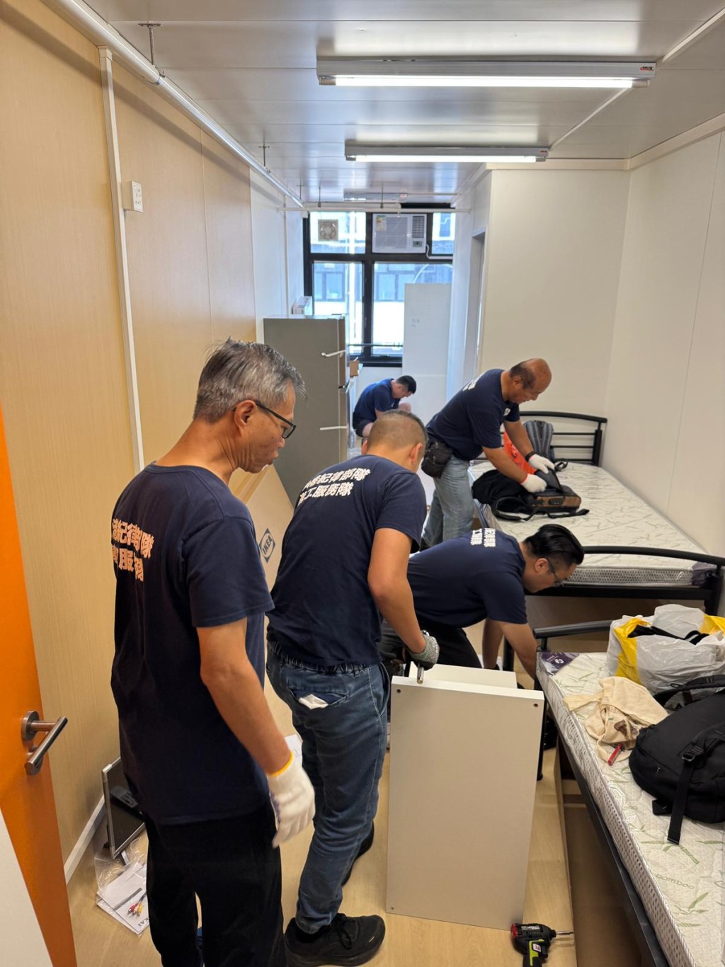多名義工隊成員為災民裝嵌家具。