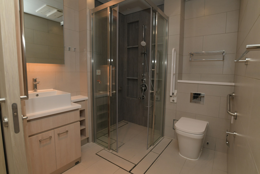 浴室以趟门开关，并设防滑地砖、扶手及无挡水槛设计的站立式淋浴间等。资料图片