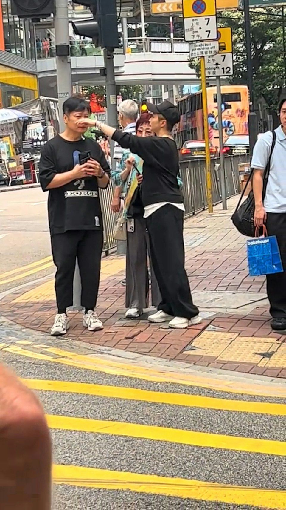 湯盈盈突然伸出手，非常細心地在街頭為老公錢嘉樂整理略顯凌亂的頭髮與面部儀容。
