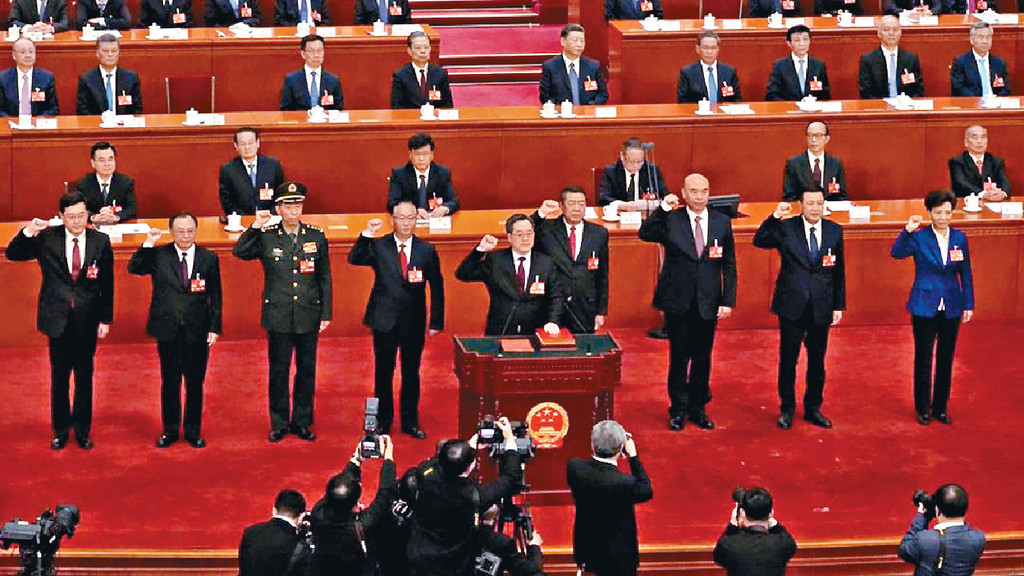 ■丁薛祥（前）带领秦刚（左）等一众官员宣誓。