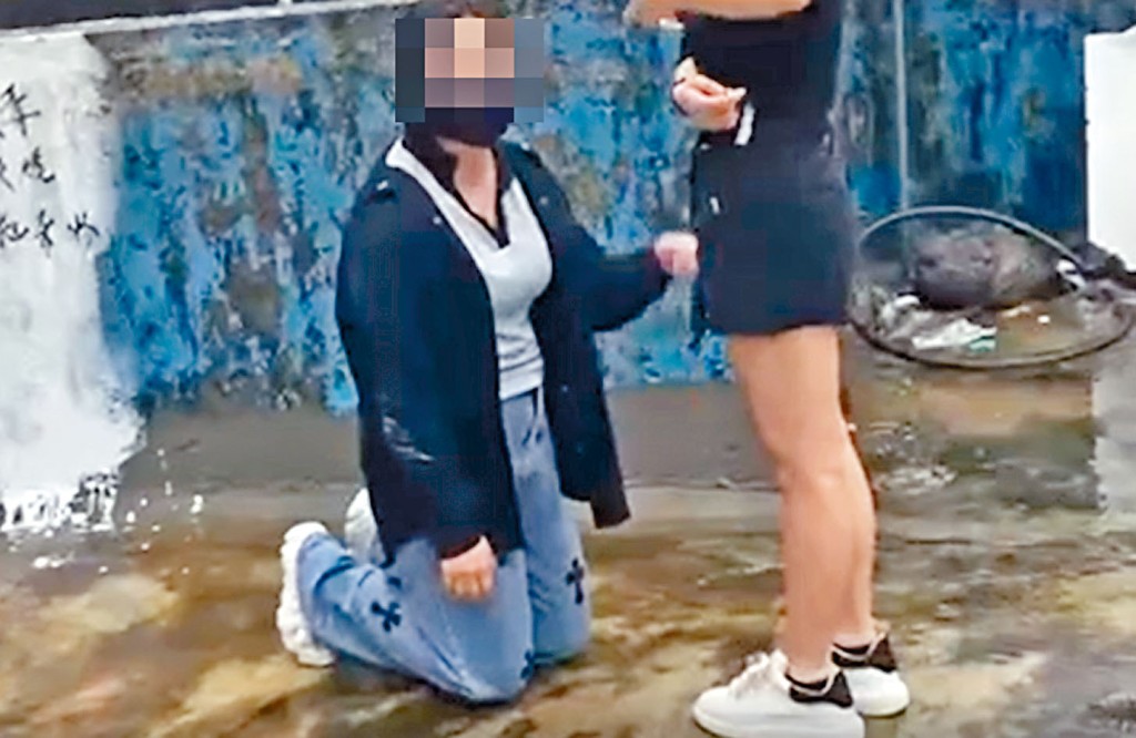 疑遭欺凌少女跪在童黨面前。