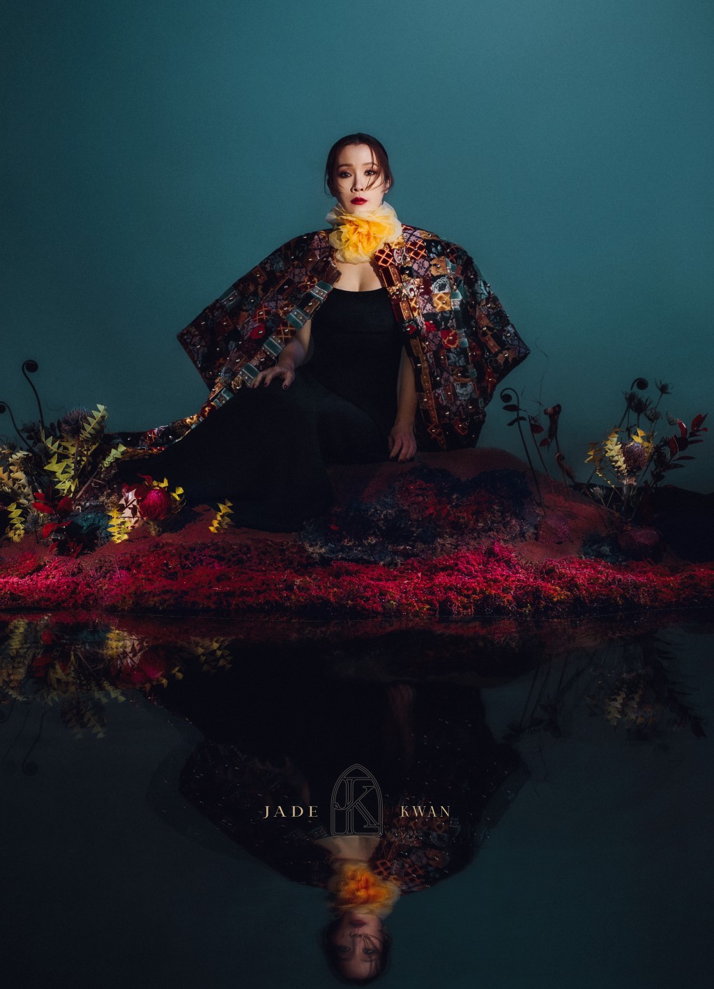 攝影師在影樓用鮮花及沙泥搭建一個小山丘讓Jade拍攝。