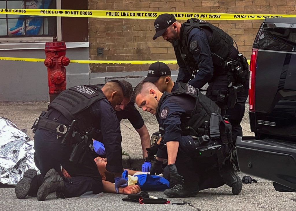 溫哥華市中心爆槍擊案，警員在現場治療一名中槍的受害者。路透社
