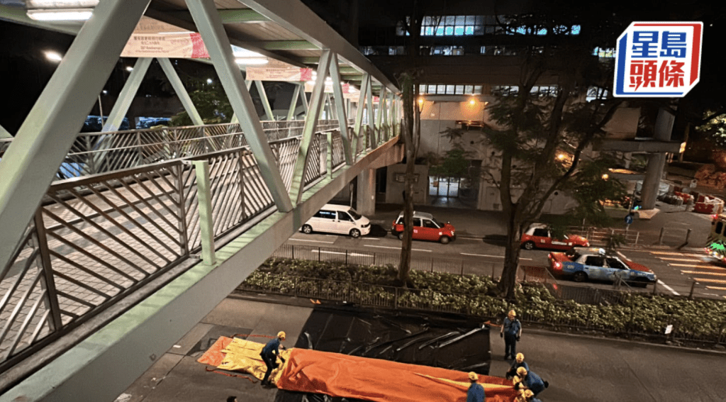 柴湾市政街市对开行人天桥有人危坐，消防员张开气垫救人。李家杰摄