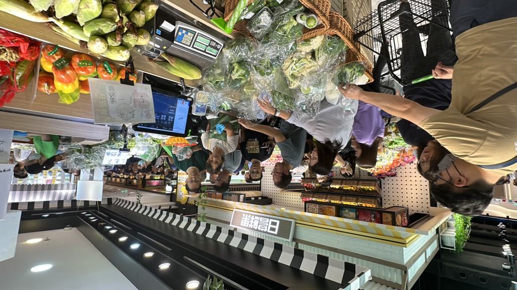 店员每摆放新蔬菜,客人立即上前抢购。(刘汉权摄) 店员每摆放新蔬菜,客人立即上前抢购。(刘汉权摄)