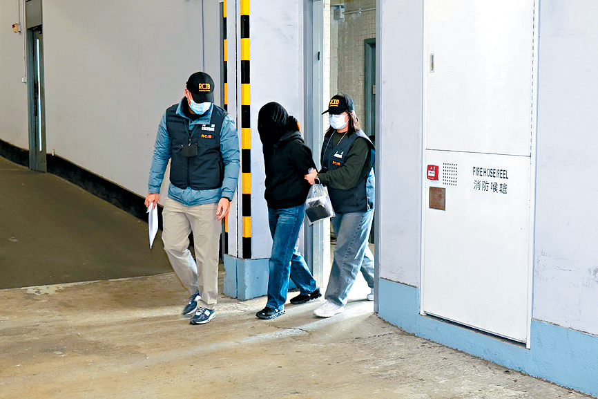 被捕女子黑布蒙頭由關員押走。