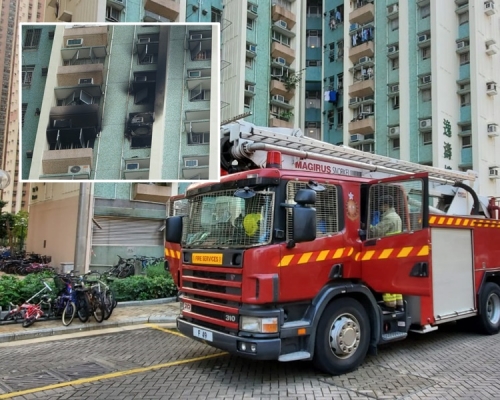 单位外墙上下被熏黑一片。杨伟亨摄