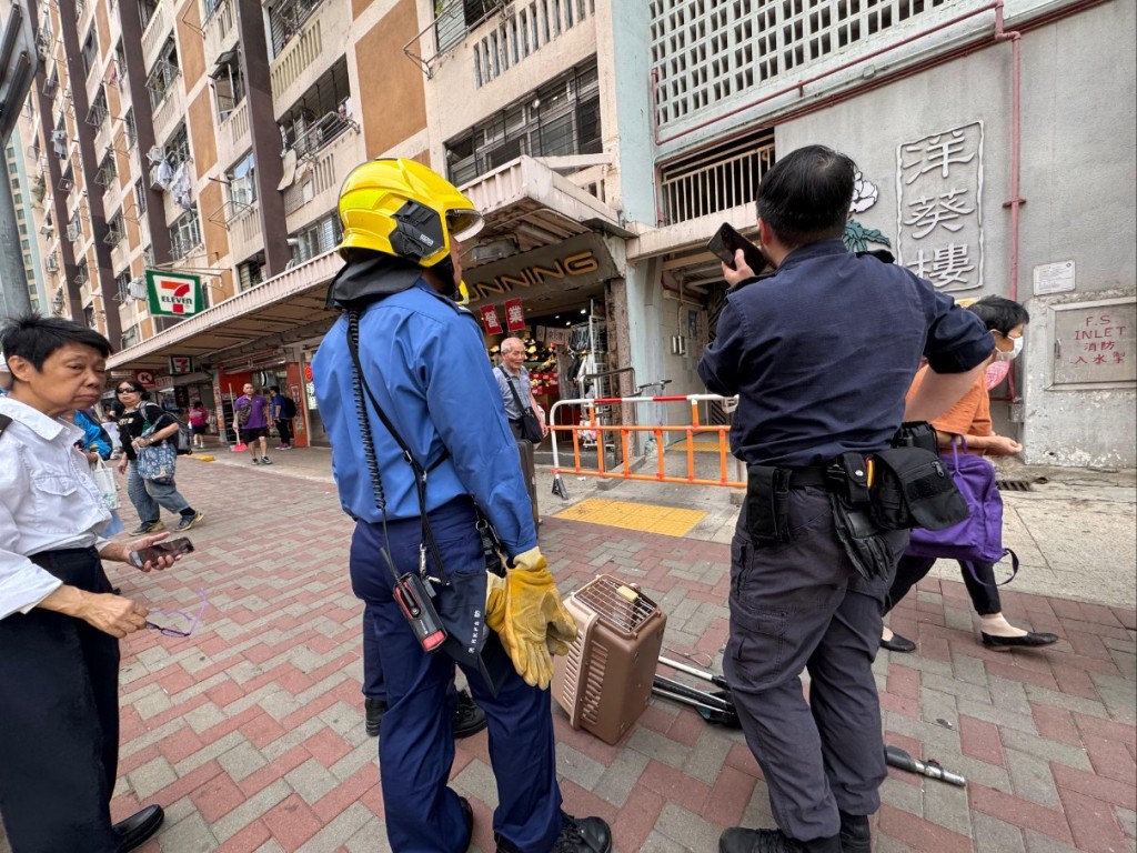 消防員及愛護動物協會人員先後趕抵現場協助救貓。黃文威攝