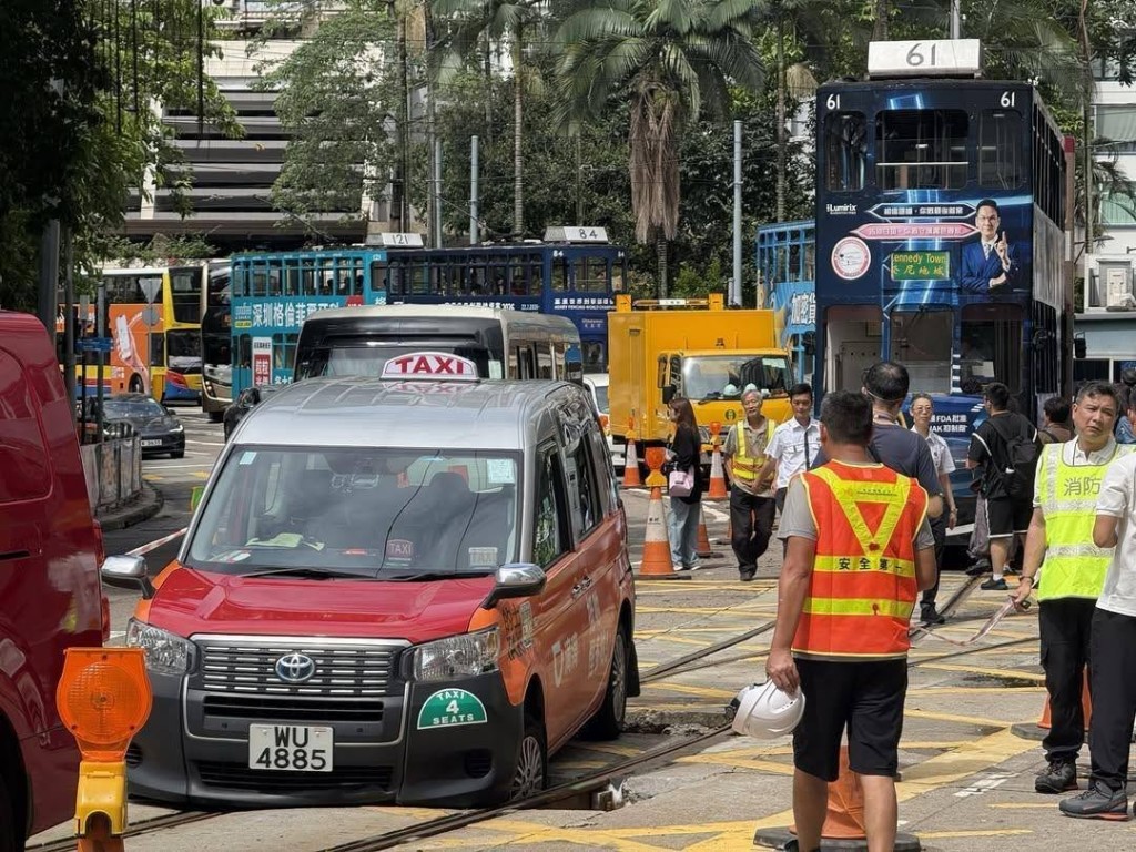 一轉的士衝入維修中的電車路軌，其前轆陷入坑內被困。網上圖片