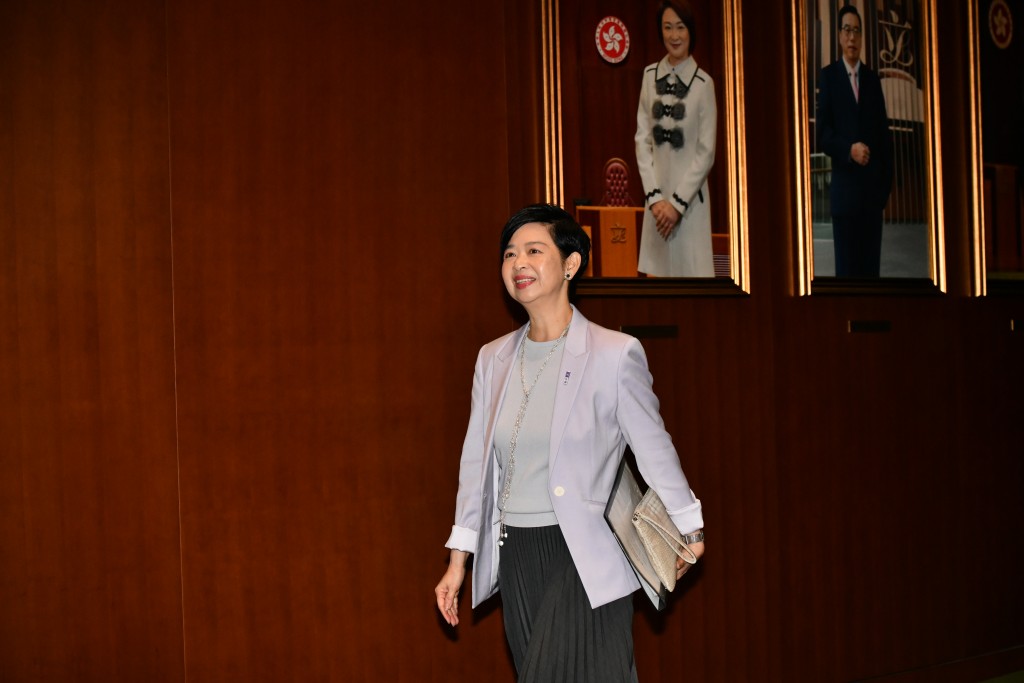 何永賢穿上淺紫色外套。 何永賢穿上淺紫色外套。
