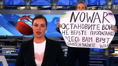 俄乌战争爆发后，奥夫相尼科娃（右）闯直播室举标语牌直指当局「说谎」。 网上图片