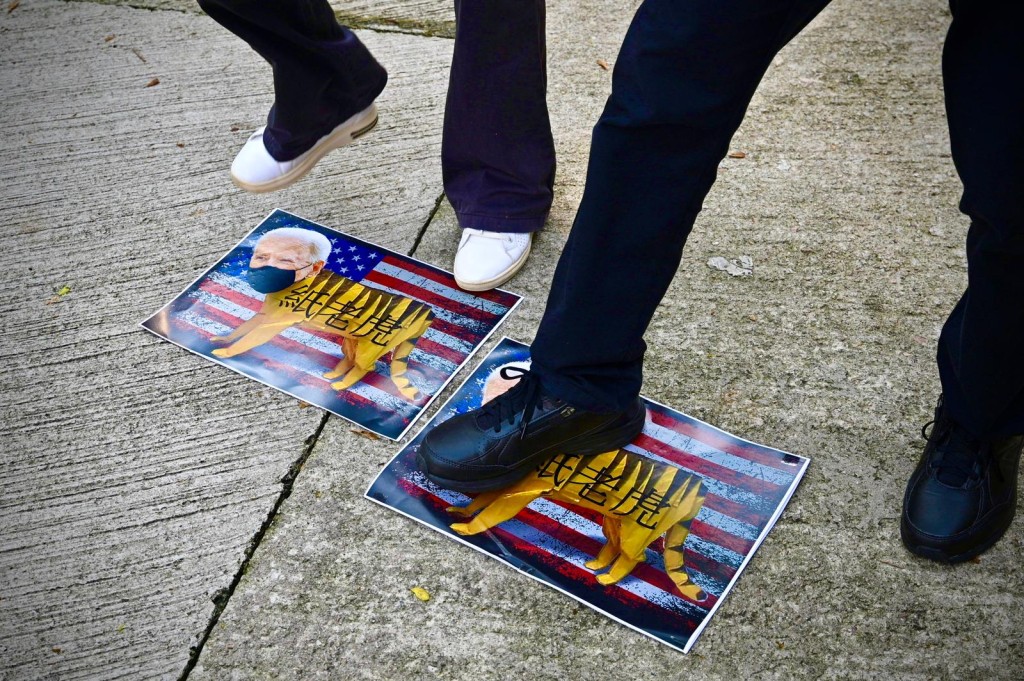 有人將印有美國總統拜登頭像的紙張放在地上狂踩。