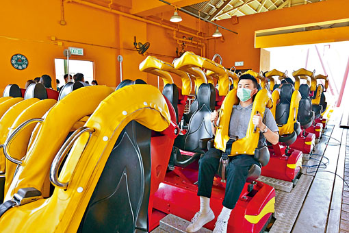 ■海洋公園重開後,互不相識的人士坐機動遊戲要隔開兩個座位。圖為模擬的防疫安排。