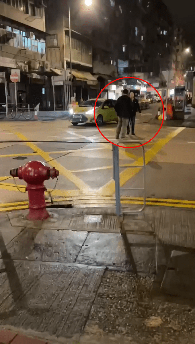 影片開頭先看到疑似的士司機(面向鏡頭)與一名拿兩傘的男子(背向鏡頭)，拉扯至馬路中間。