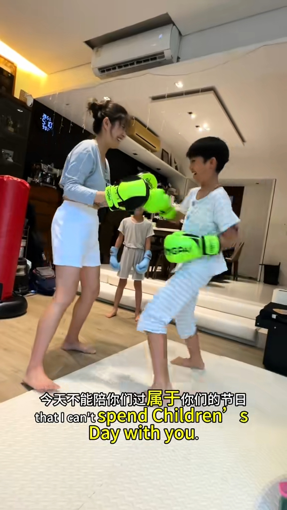 周家蔚与儿子玩拳击的亲子活动。
