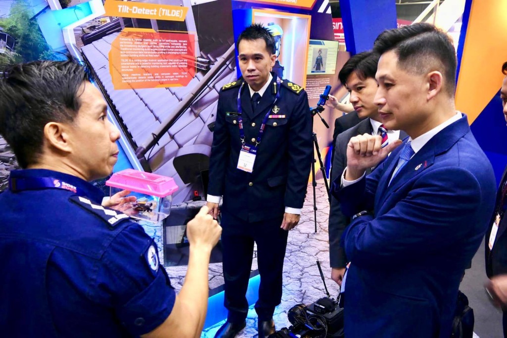 消防處處長楊恩健（右）聽取新加坡民防部隊代表介紹消防救援的最新科技。香港消防處fb圖片