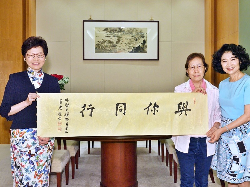 林太成為特首後,饒公參考了她的競選口號「同行WE CONNECT」,再贈四個大字「與你同行」。資料圖片