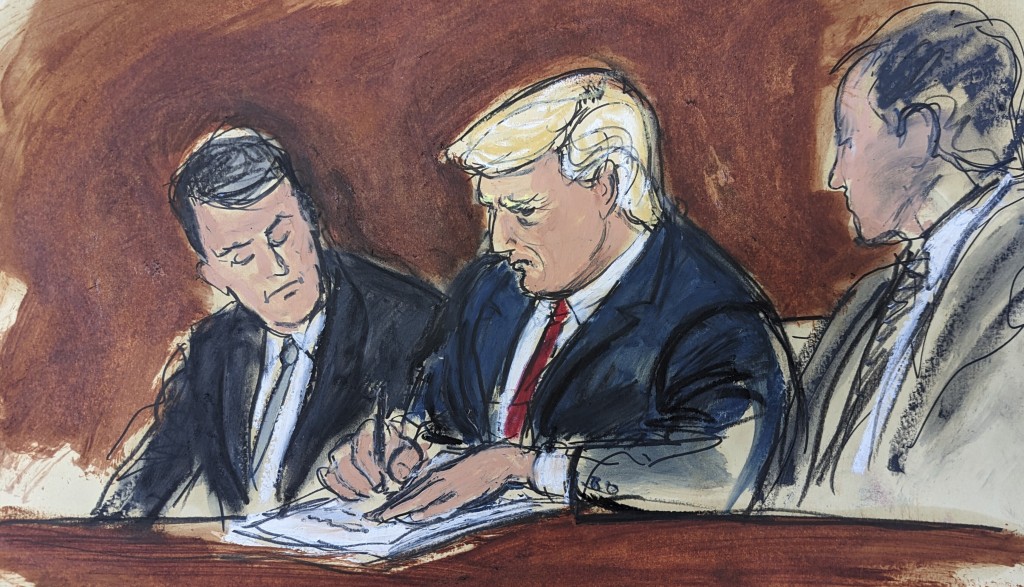 特朗普在法庭文件签字。 美联社
