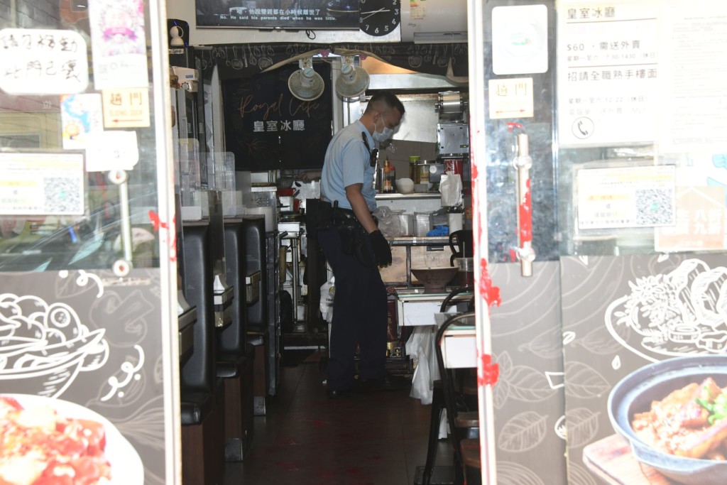 警員在餐廳內調查，可見門口亦沾有紅油漆。
