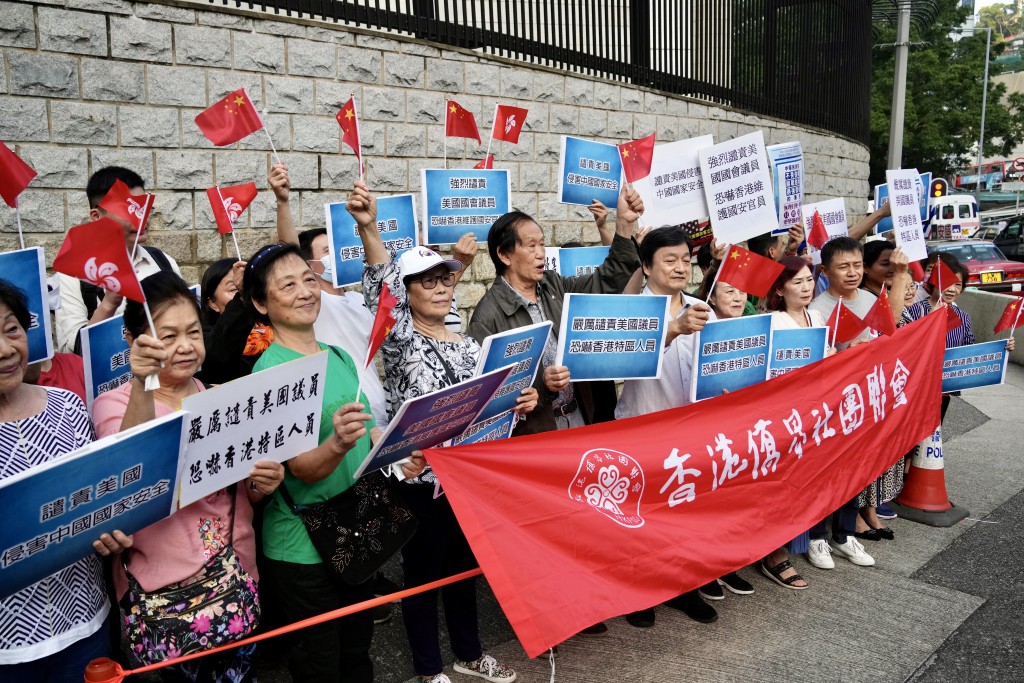香港僑界社團聯會成員在場揮舞五星紅旗及特區區旗。蘇正謙攝