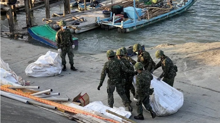 軍方人員在海上撈起部分戰機殘骸。網上圖片