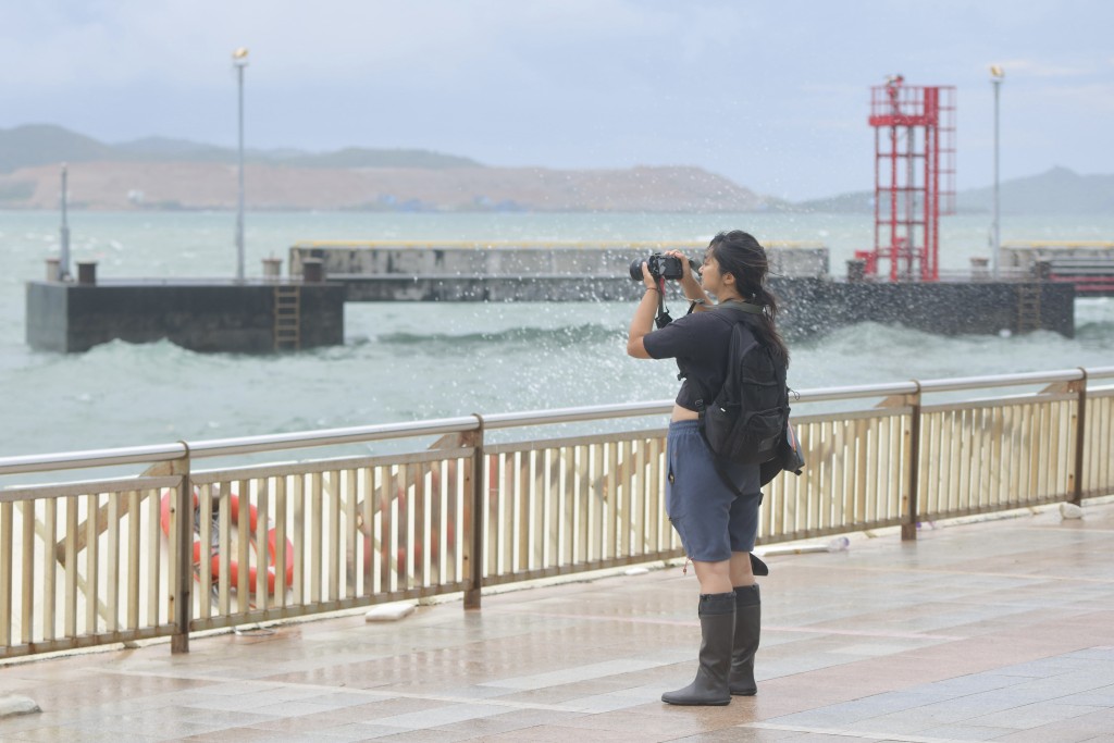 有巿民在杏花村海傍拍照。歐樂年攝