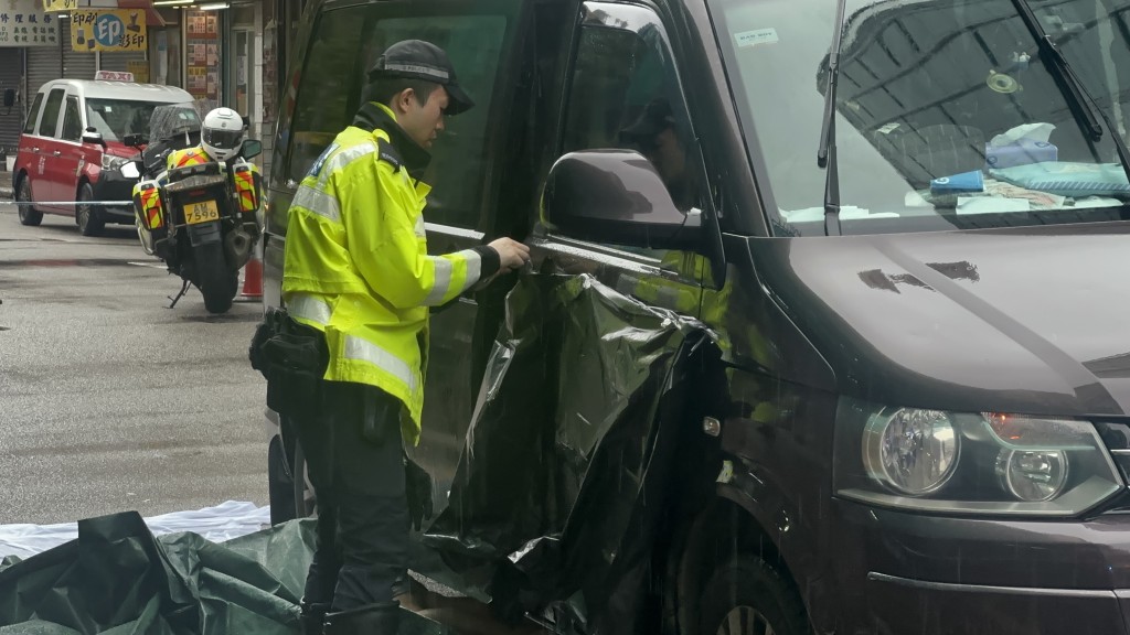 警員用黑膠袋遮蔽貨Van涉事位置。