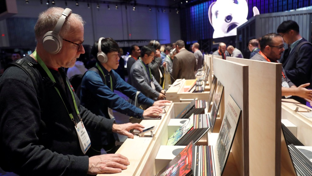 消费电子展（CES）参观者试用降噪耳机听音乐。 路透社