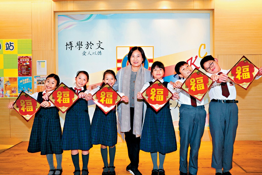 博愛醫院陳國威小學校長韋淑貞（中）與學生手持揮春合照。