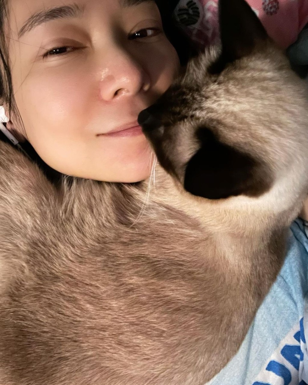 郭羡妮昨日分享与猫猫的床上素颜照。