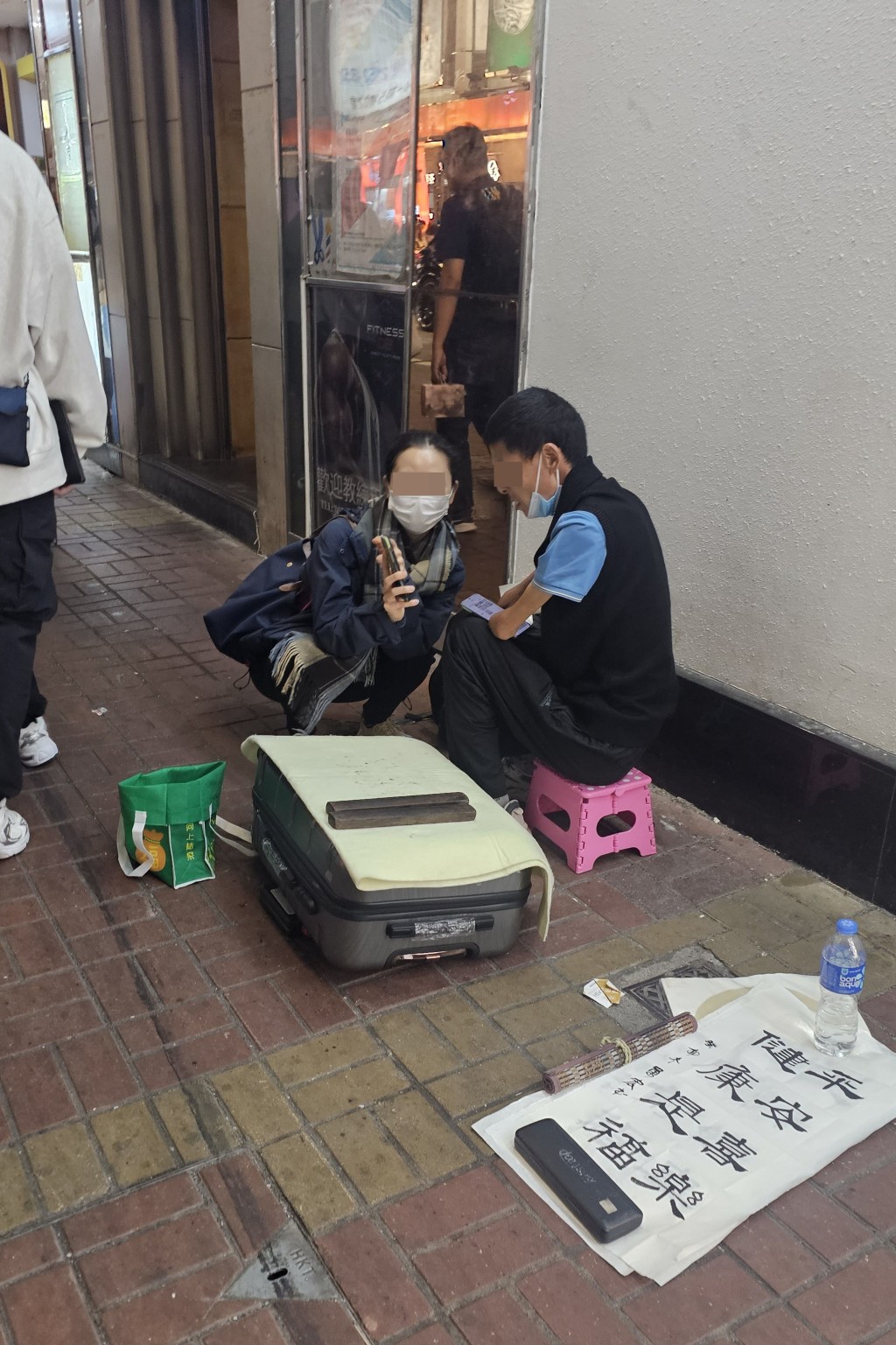 女途人出言安慰在旺角擺賣的殘障「藝術家」。  徐裕民攝